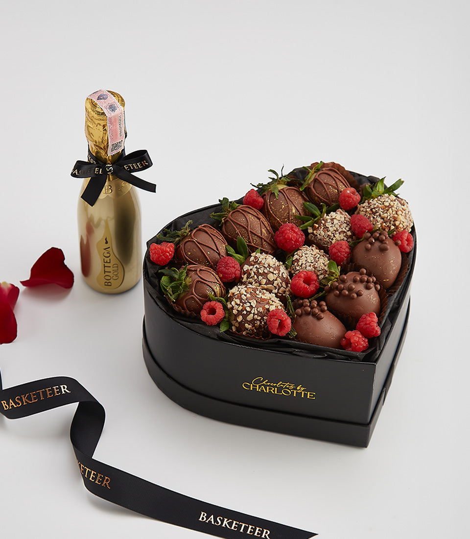 Dark chocolate strawberries with Bottega Gold sparkling wine in heart-shaped gift box, romantic wine pairing with fresh