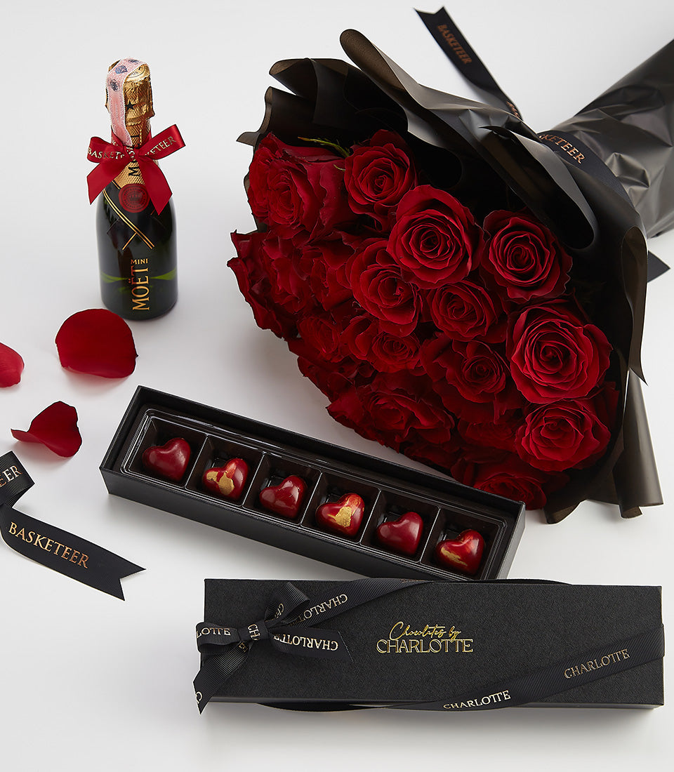 Luxury Valentine gift set with red roses, Moët champagne, and heart-shaped chocolates by Charlotte