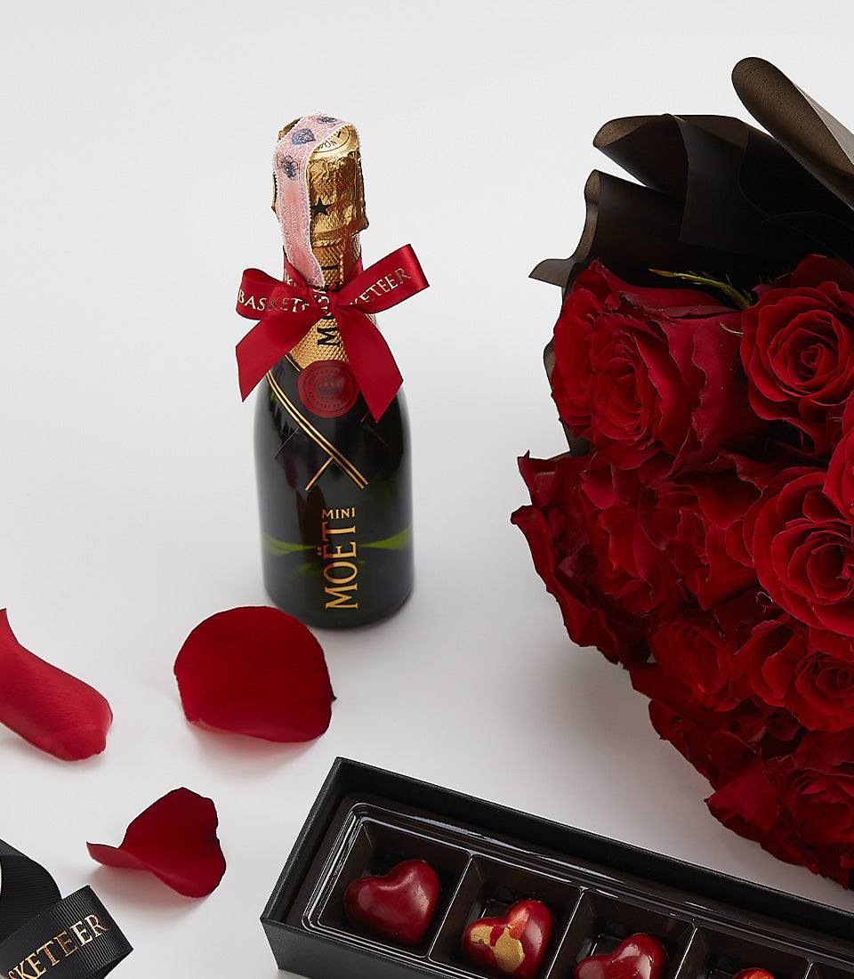 Red roses, Moët champagne, and heart-shaped chocolates Valentine gift set with rose petals