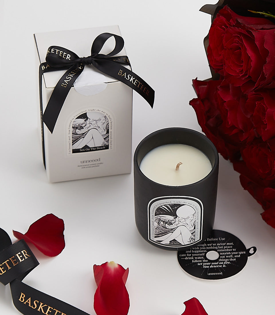 Luxury Valentine's gift set with red roses, scented candle, and black ribbon gift box