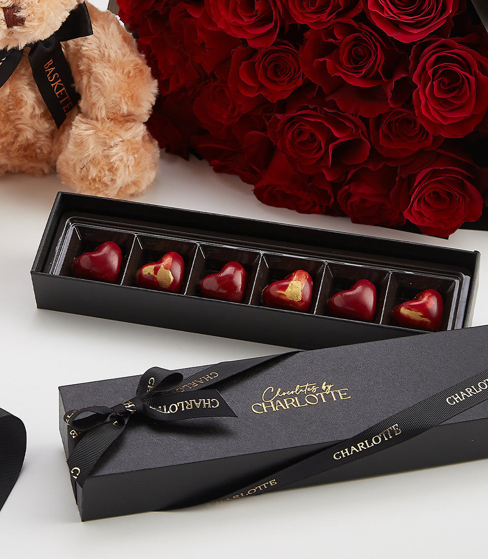 Red roses, teddy bear, and heart-shaped chocolates luxury Valentine's Day gift set