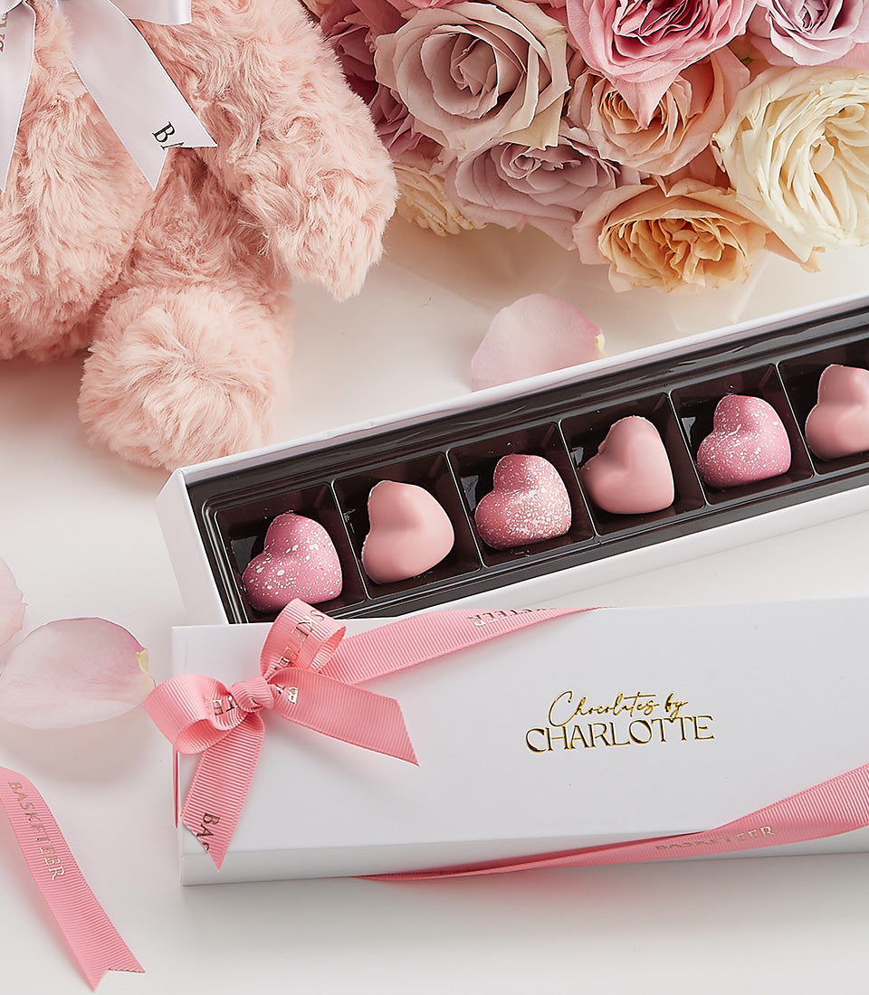 Luxury Valentine's gift bundle with pink teddy bear, fresh rose bouquet, and heart-shaped chocolates by Charlotte
