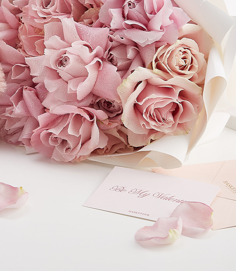 Fresh pink roses with white wrapping and Valentine's Day card, luxury gift bundle