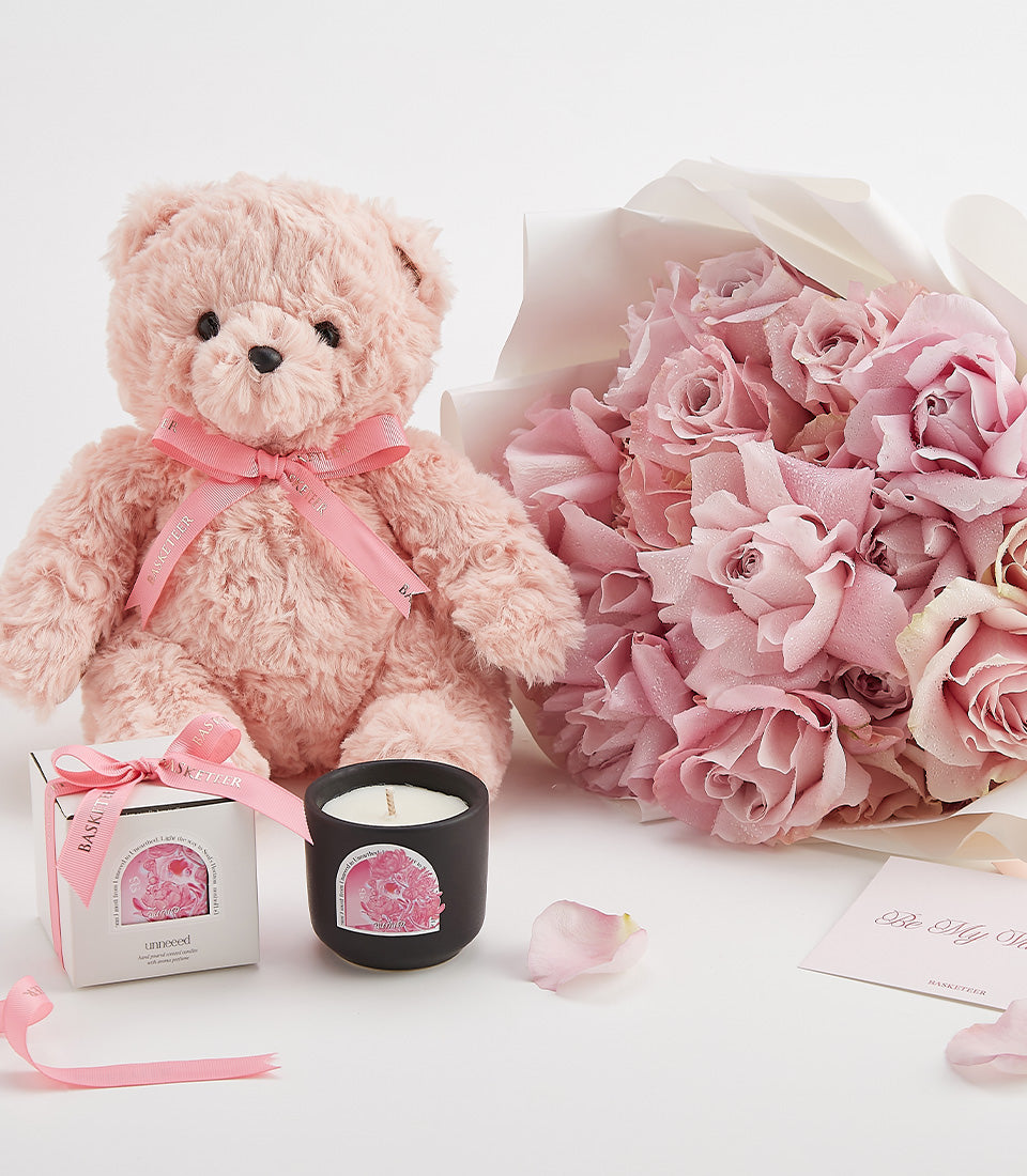 Pink teddy bear with rose bouquet, candle, and petals Valentine's Day luxury gift bundle