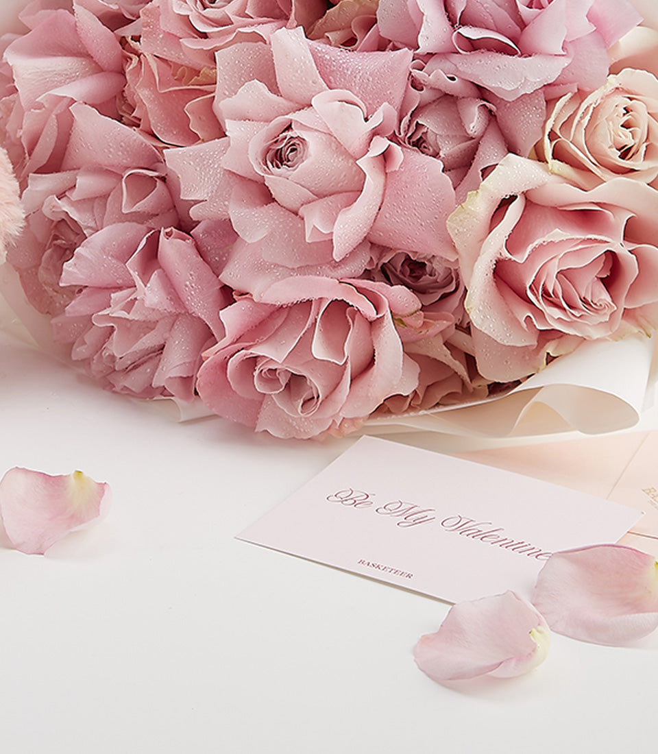 Fresh light pink roses with perfume in romantic Valentine's Day gift set, featuring delicate petals and white wrapping