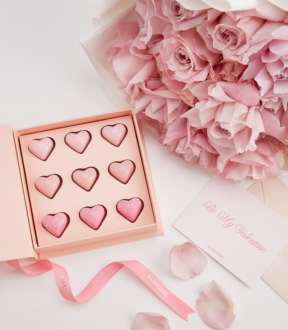 Light pink roses with heart-shaped chocolates and Valentine's card in luxury gift set