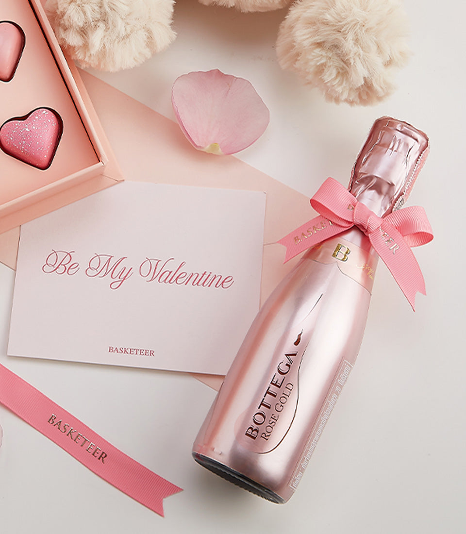 Rosé sparkling wine with heart-shaped chocolates and Valentine's card, romantic gift set