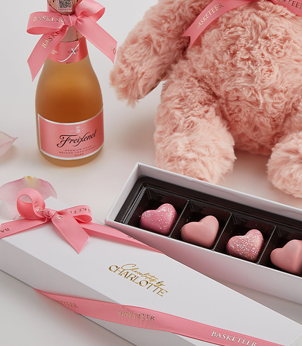 Rosé sparkling wine, pink teddy bear, and heart-shaped chocolates Valentine gift set