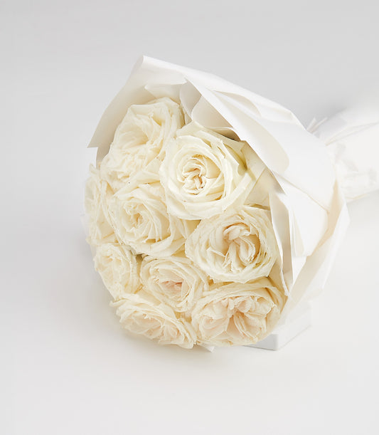 Dozen creamy white roses elegantly wrapped in white paper, Valentine's Day gift bouquet