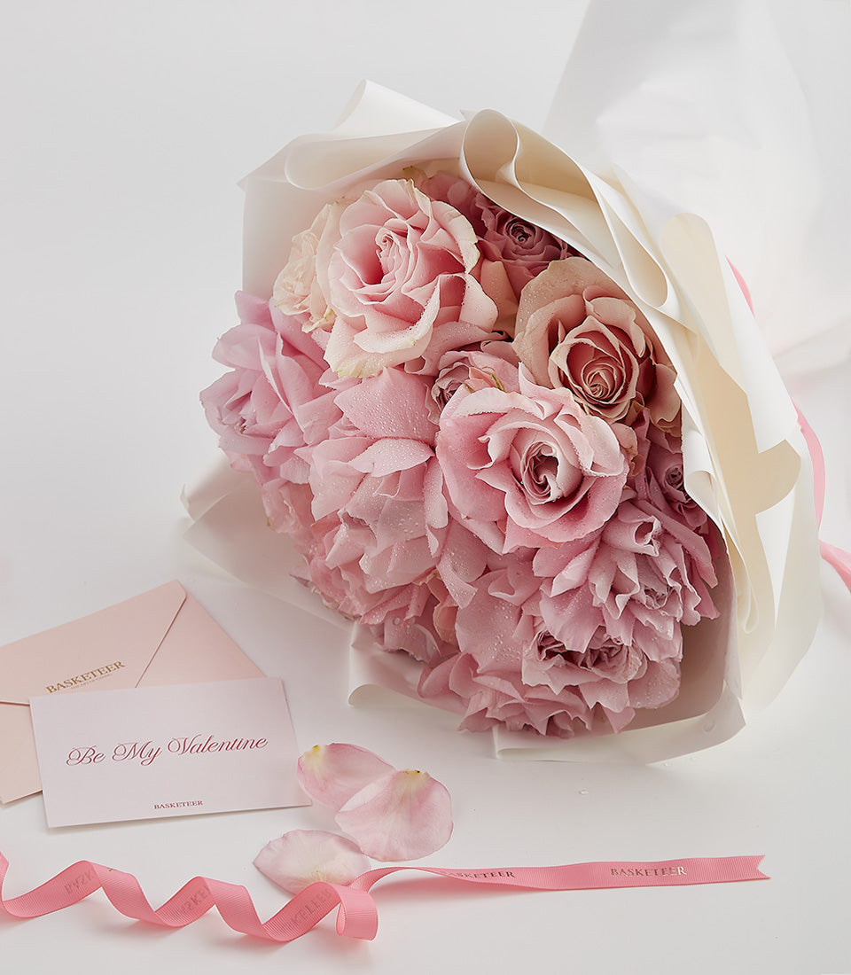 Pink and white Valentine's Day rose bouquet with love note and ribbon