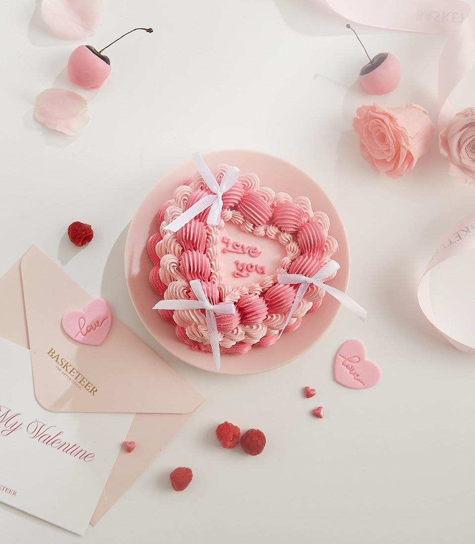 Pink heart-shaped cake with ruffled frosting, love message, and fresh roses Valentine's Day gift set