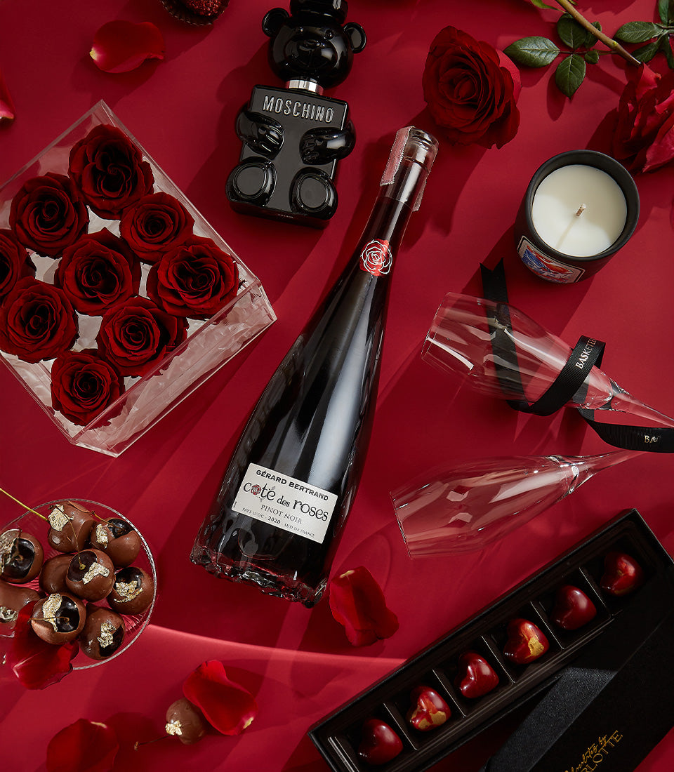 Luxury Valentine's gift set with red roses, Pinot Noir wine, teddy bear perfume, heart chocolates and champagne flutes