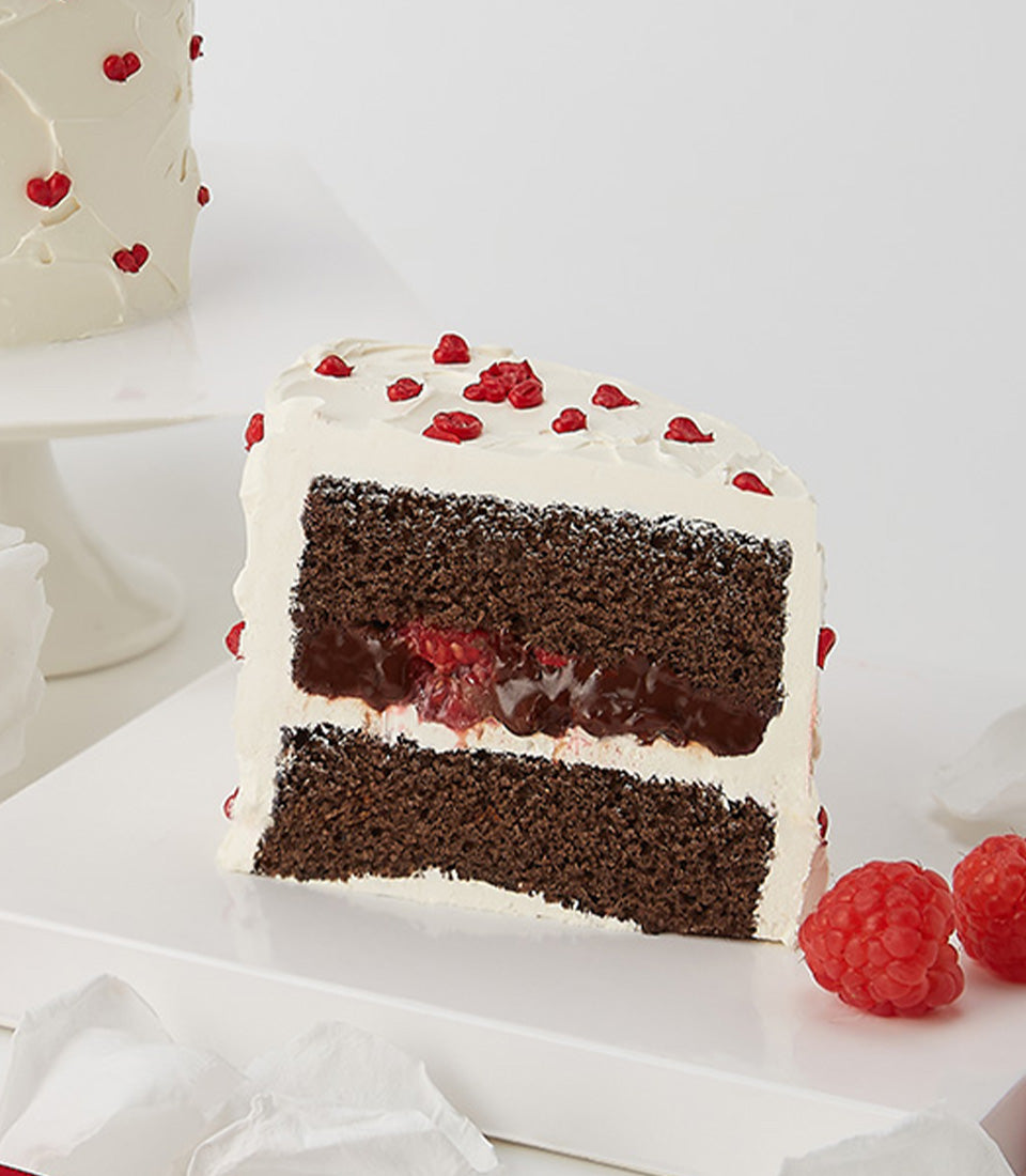 Rich chocolate and raspberry layer cake with heart sprinkles, perfect Valentine's gift from Charlotte Bakery