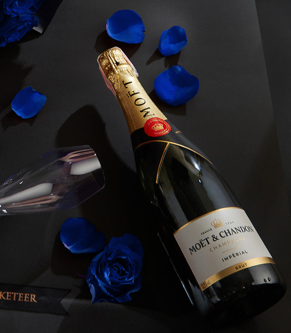 Luxury champagne gift set with Moët & Chandon, champagne flute, and blue roses for Valentine's Day