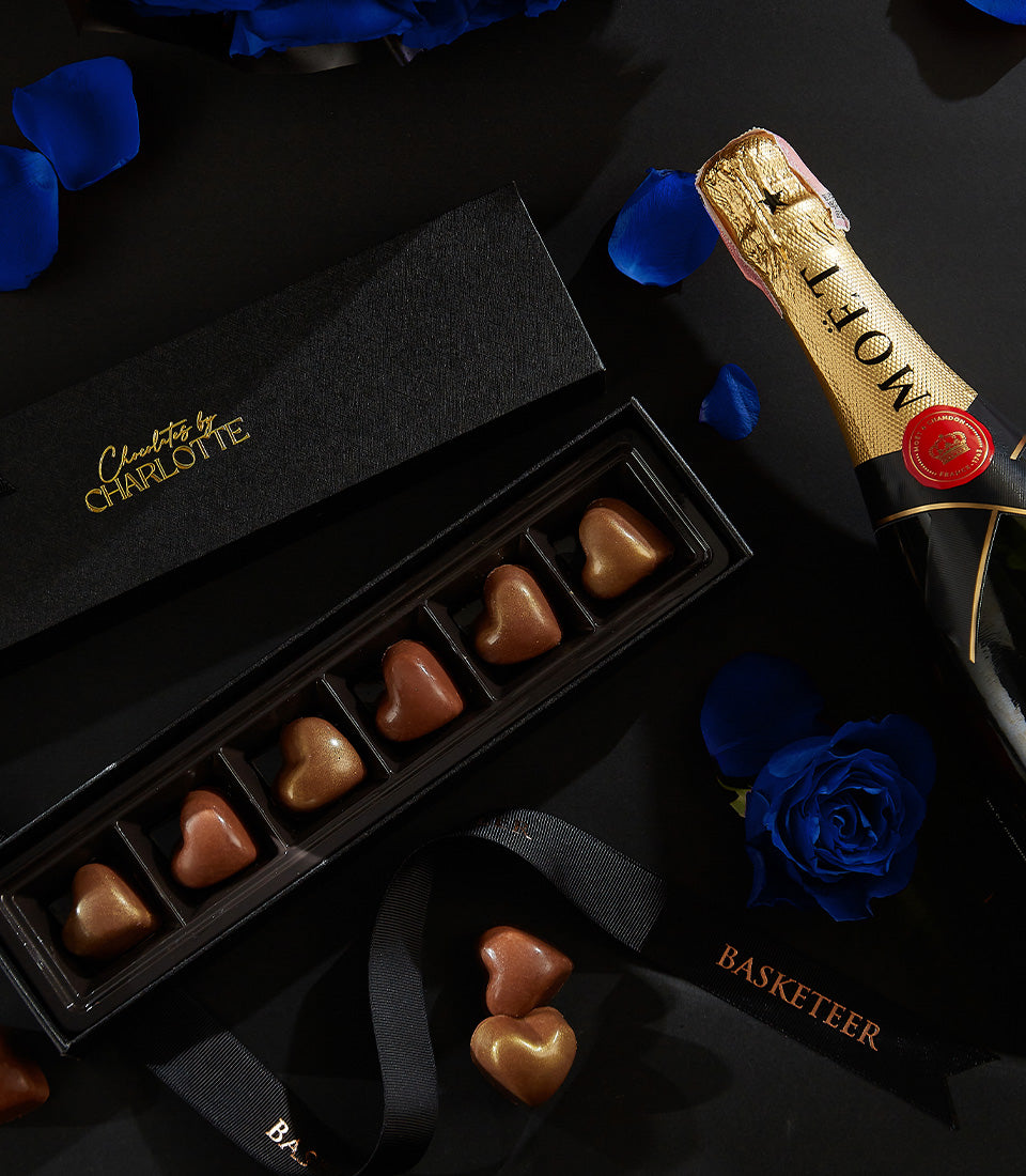Luxury champagne and heart-shaped chocolate gift set with blue roses for Valentine's Day