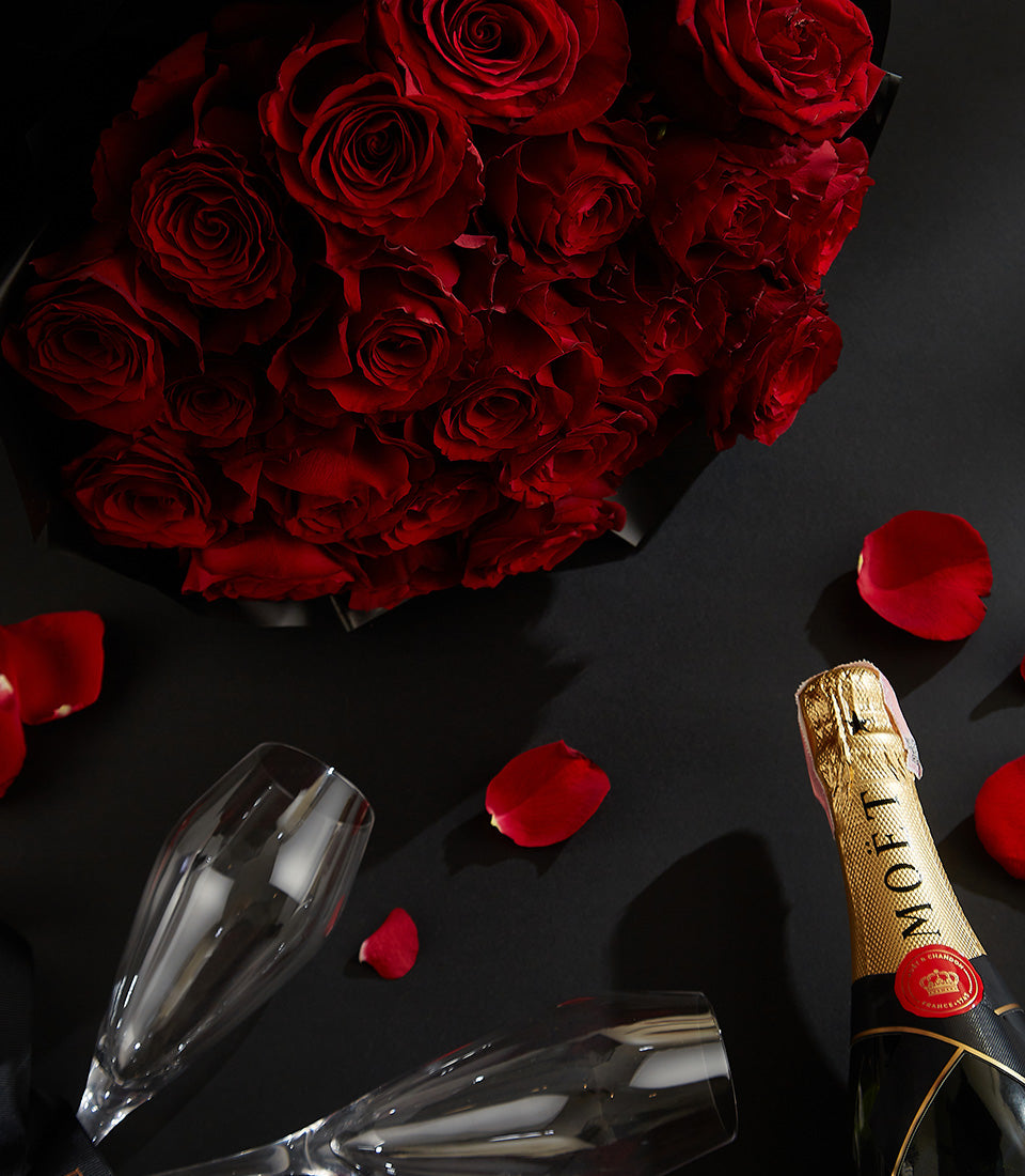 Romantic champagne and red rose gift set with Ecuador roses, sparkling wine, and champagne flutes for Valentine's Day