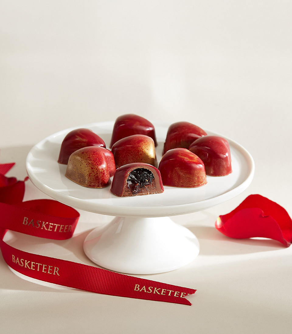 Luxury Valentine's chocolate and champagne gift set with red rose petals and golden ribbon