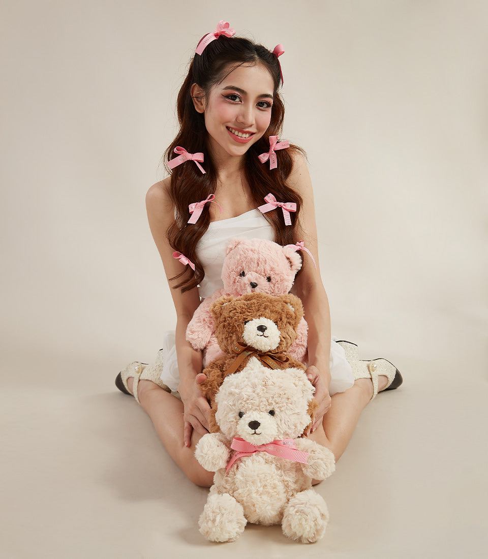 Cuddly teddy bear gift set with pink, brown, and cream plush bears stacked together