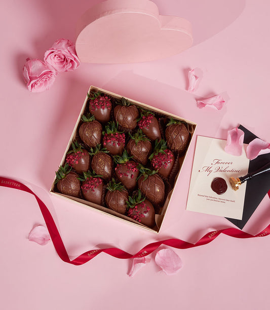 Dark chocolate-covered strawberries with gold glitter in luxury Valentine gift box from Charlotte Bakery