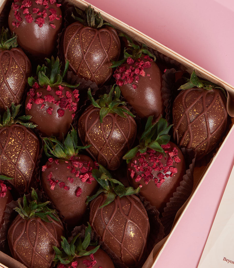Charlotte Bakery chocolate-covered strawberries, a British bakery Thailand treat. Some are topped with dried raspberry, others with gold lattice. Perfect artisan cake order for Valentine's in Bangkok.