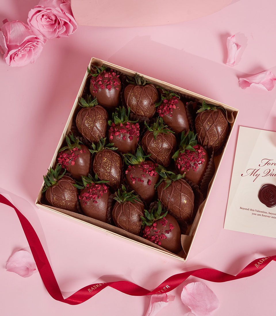 Dark chocolate-covered strawberries with gold leaf and dried fruit in luxury Valentine gift box