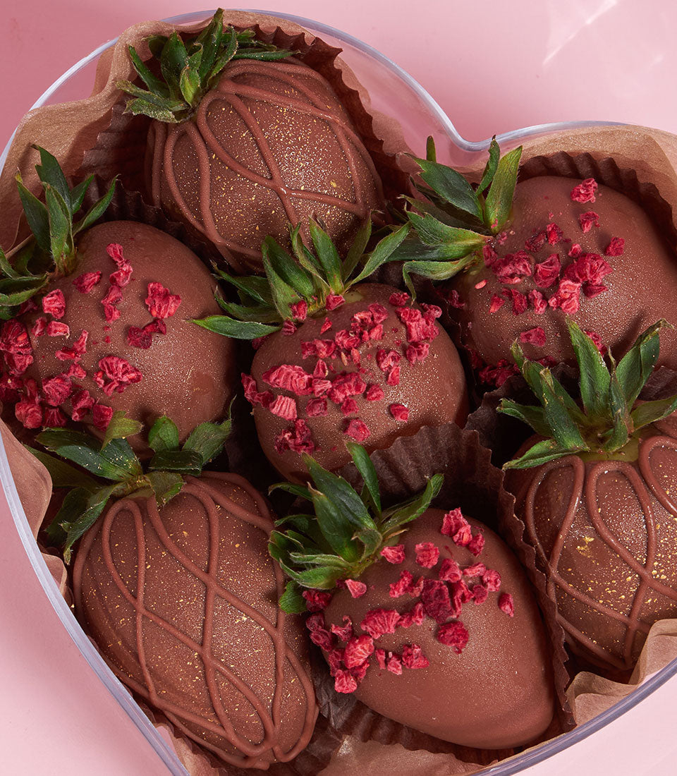 Dark chocolate-covered strawberries with gold glitter in heart-shaped Valentine gift box from Charlotte Bakery
