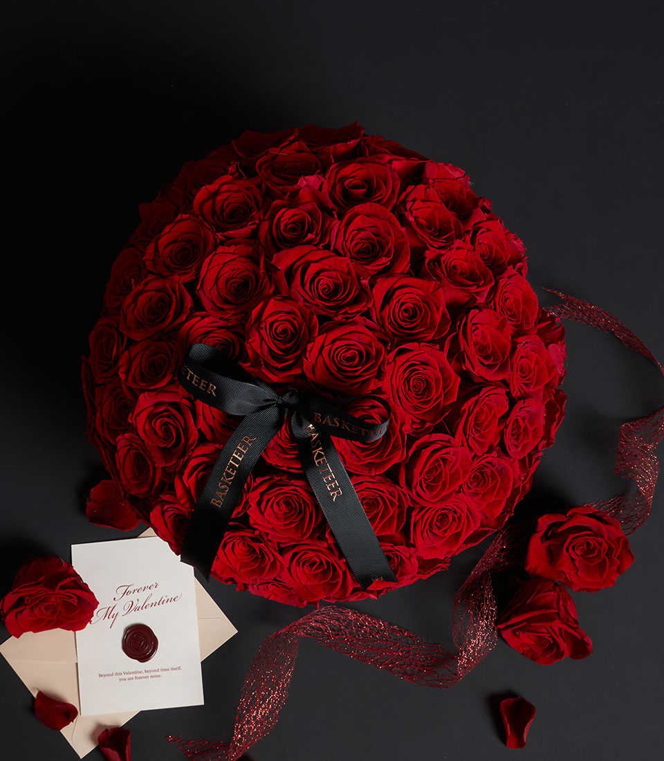 Luxury red preserved roses hat box with black ribbon, envelope card, and loose petals for Valentine's Day