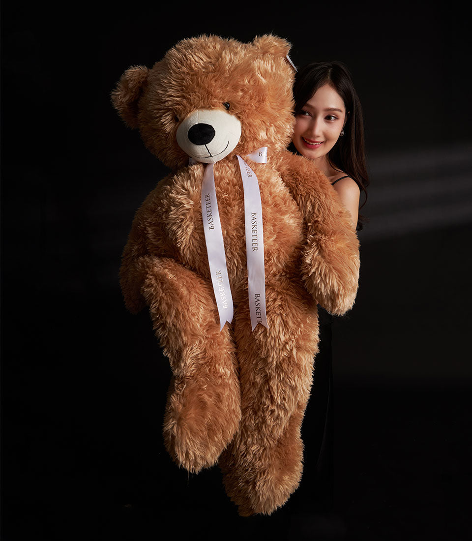 Oversized light brown plush teddy bear with white ribbon Valentine gift from Basketeer