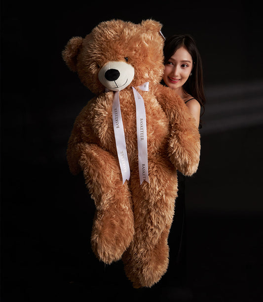 Oversized light brown plush teddy bear with white ribbon Valentine gift from Basketeer