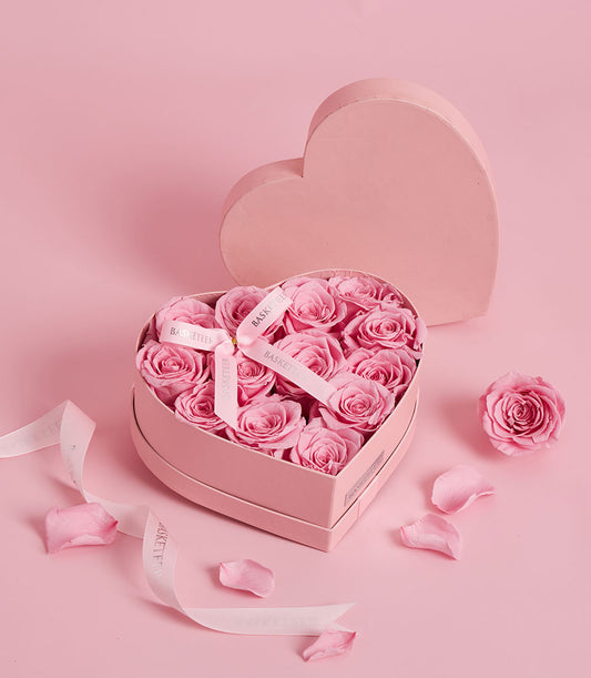 Pink preserved roses in heart-shaped gift box, elegant Valentine's Day flower gift