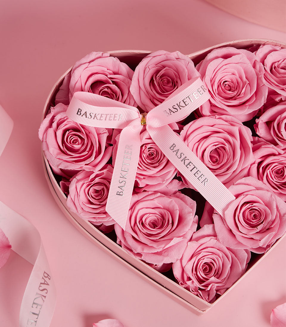Elegant pink preserved roses arranged in heart-shaped VIP gift box with ribbon, Valentine's Day gift