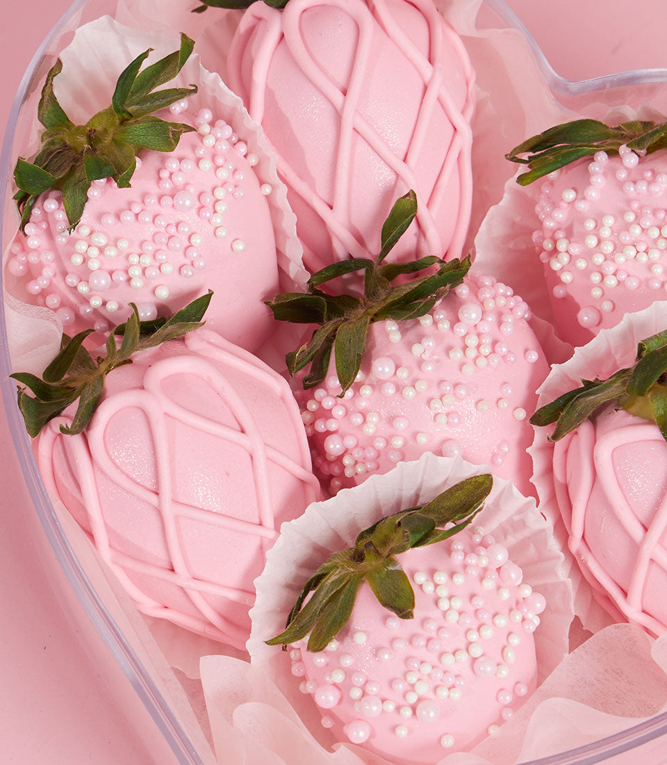 Charlotte Bakery's Valentine's treat: Pink chocolate-covered strawberries in a heart-shaped box. Artisan-decorated with sprinkles and chocolate drizzle. Order a custom cake Bangkok!