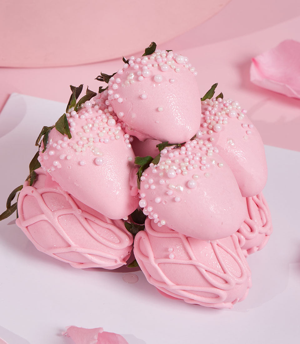 Charlotte Bakery's Valentine's treat: Pink chocolate-covered strawberries with delicate pearl sprinkles. Some have a chocolate drizzle design. Order artisan cake Bangkok!