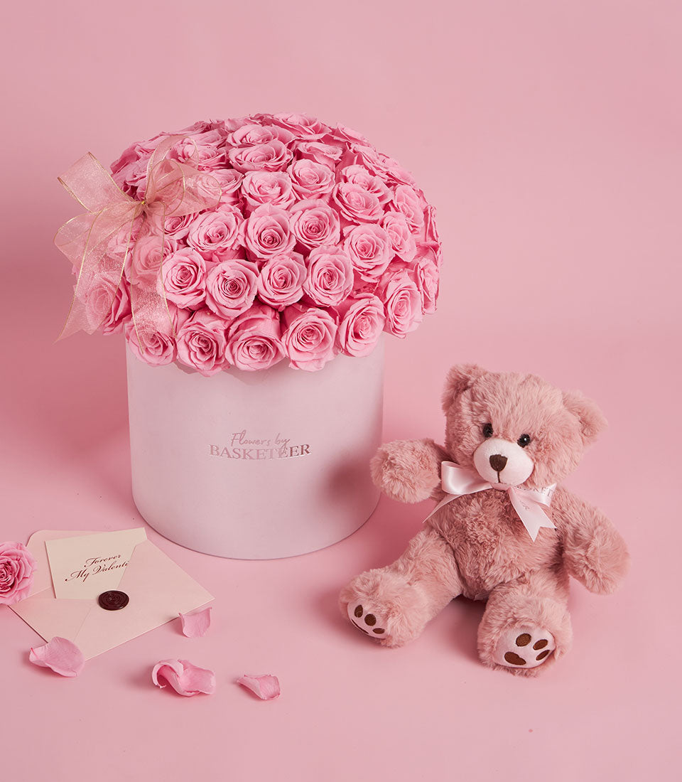 Preserved pink roses in white hatbox with pink teddy bear and love note for Valentine's Day