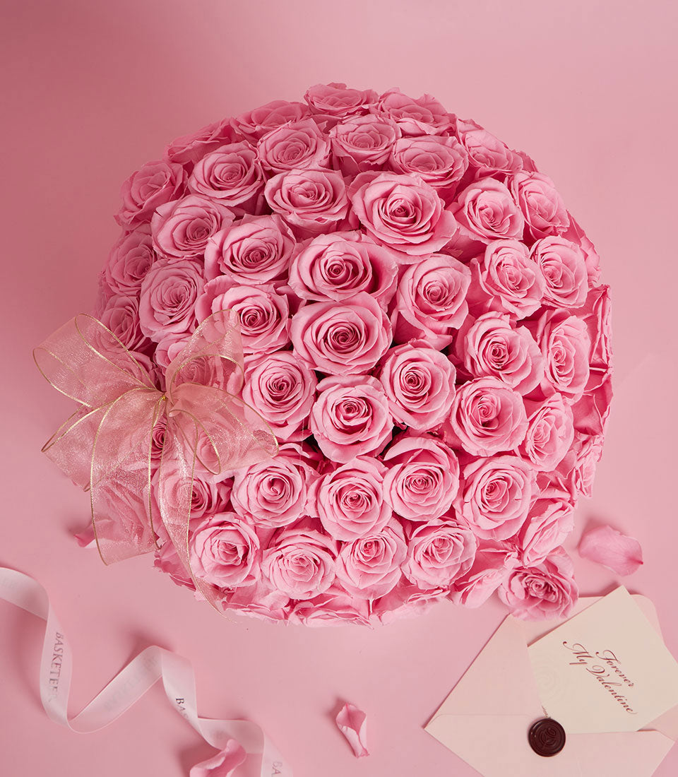 A dome-shaped bouquet of preserved pink roses, a luxurious flower delivery from Flowers by Basketeer in Bangkok. Finished with sheer ribbon and a love note.