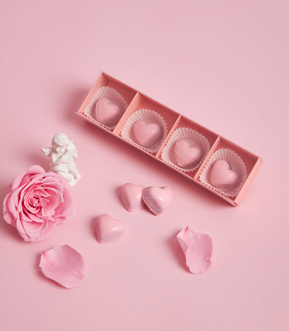 Charlotte Bakery artisan cake bonbons: pink heart-shaped chocolates in a gift box, ready for birthday cake delivery Bangkok. British bakery Thailand sweetness.