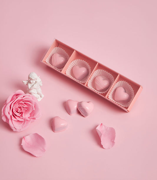 Charlotte Bakery artisan cake bonbons: pink heart-shaped chocolates in a gift box, ready for birthday cake delivery Bangkok. British bakery Thailand sweetness.