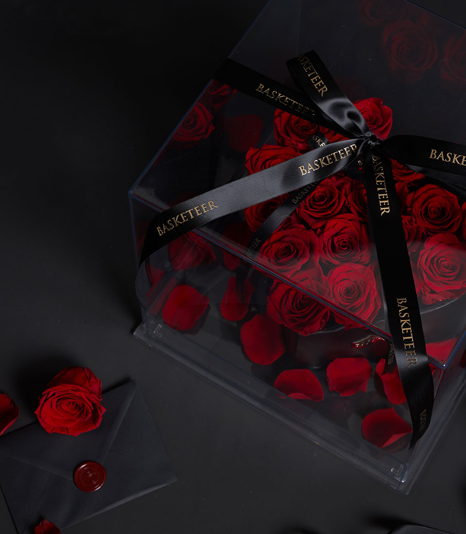 Eternal Red Preserved Rose Luxury Box with black satin ribbon, clear acrylic case, and romantic rose petals for Valentine's