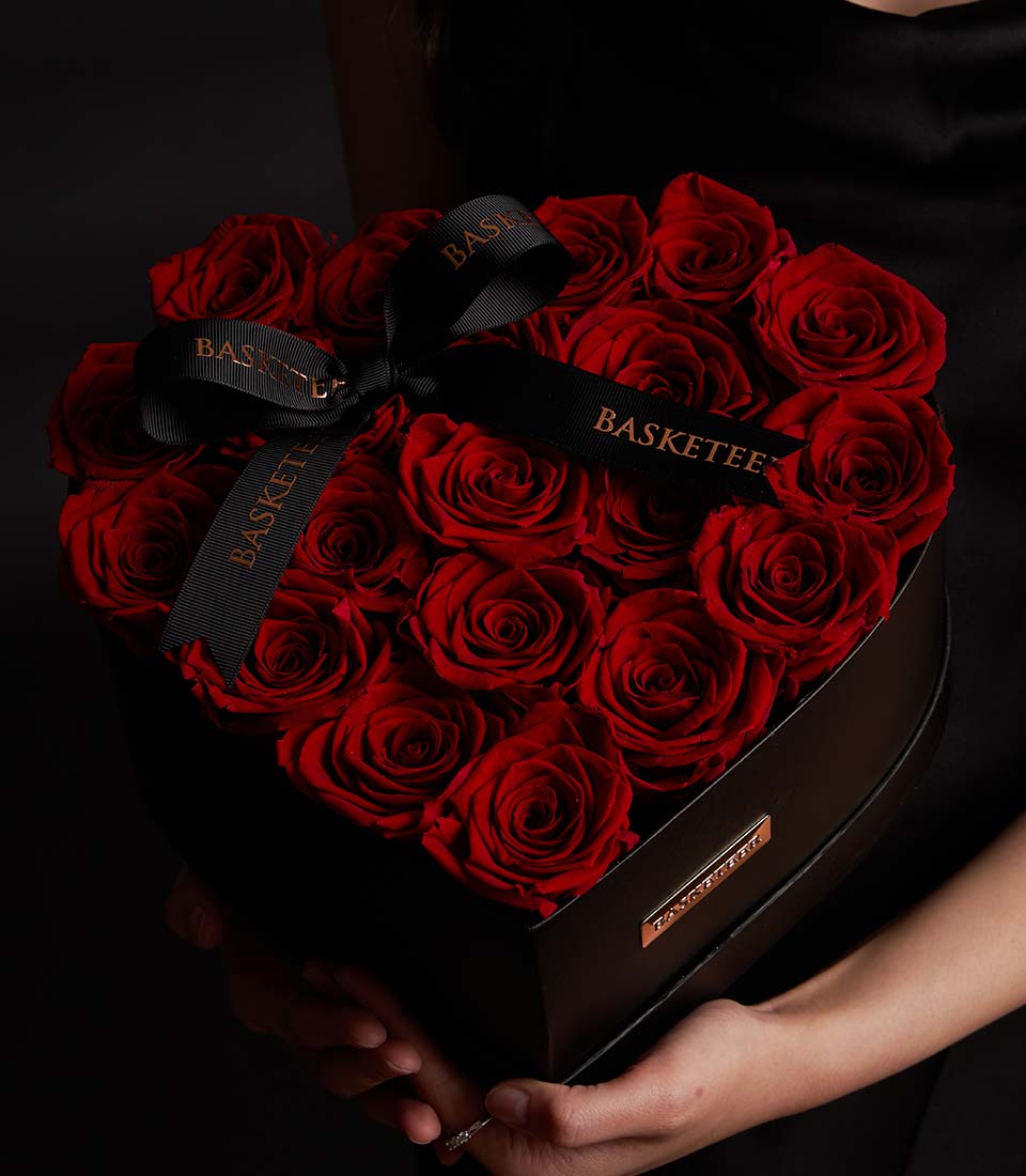 Red preserved roses in black heart-shaped luxury box, Valentine's Day gift with metallic ribbon bow
