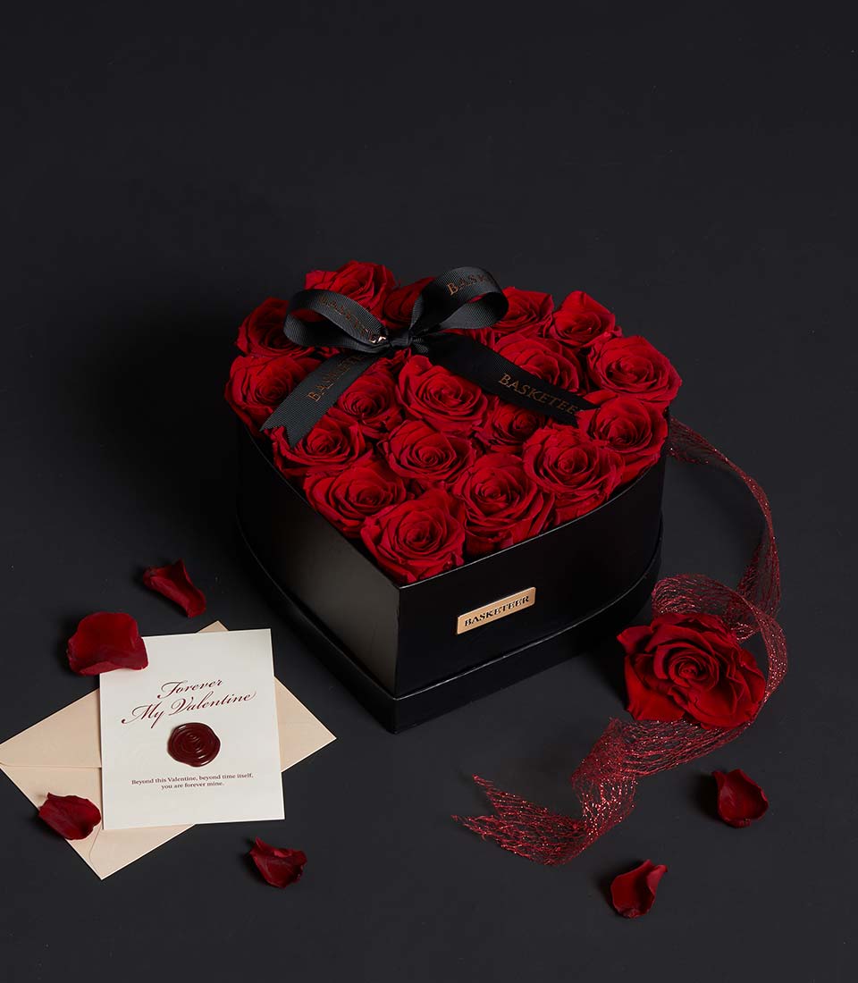 Luxury red preserved rose heart box with black ribbon, cream envelope, and Valentine's Day card with red wax seal
