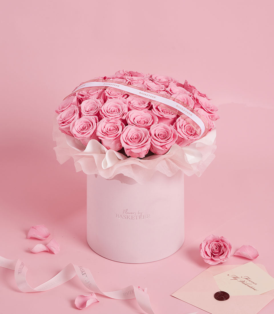 Sweet pink preserved rose arrangement in a round Flowers by Basketeer box. A luxurious, long-lasting gift for flower delivery in Bangkok, Thailand.