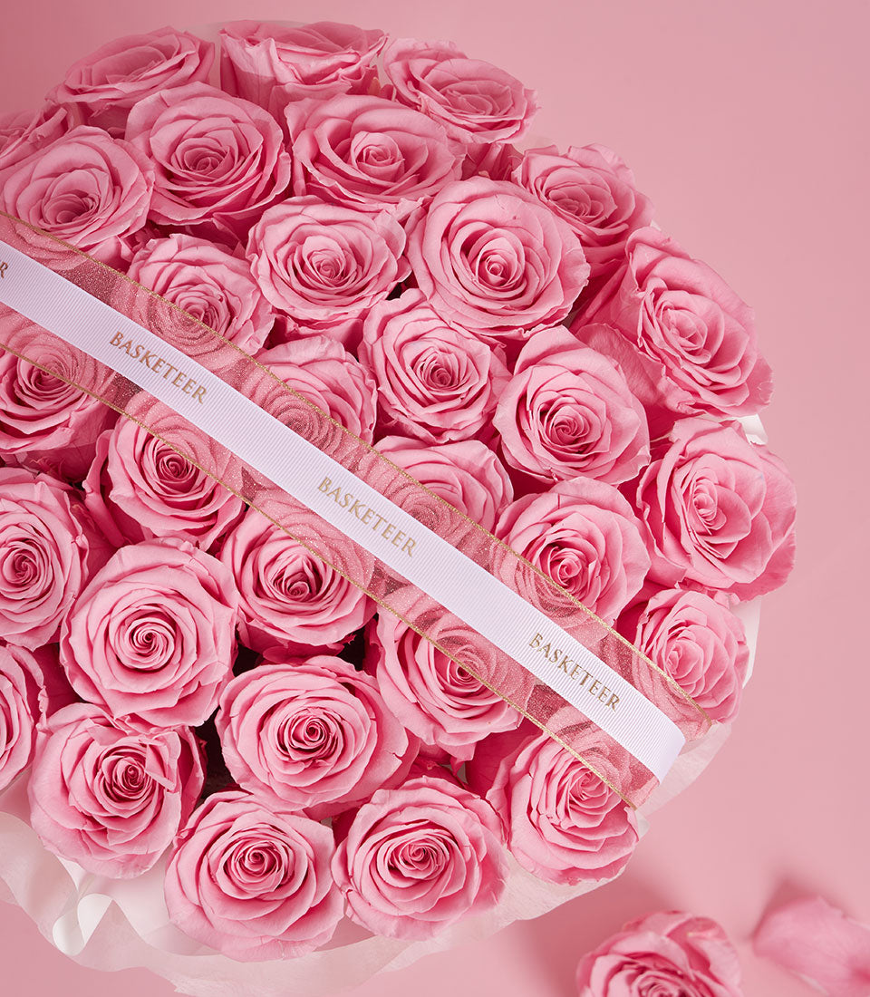 Round arrangement of preserved pink roses in elegant VIP box with gold-trimmed ribbon, Valentine's Day gift