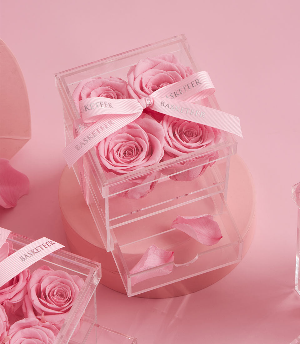 Sweet pink preserved roses from Flowers by Basketeer in a luxurious acrylic gift box with a delicate ribbon. Perfect flower delivery Bangkok.