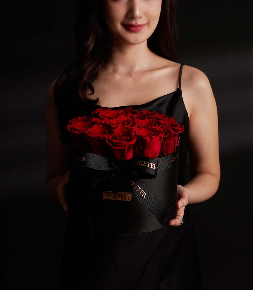Lush preserved red roses from Flowers by Basketeer in a round black box with a branded ribbon. Perfect for premium flower delivery in Bangkok.