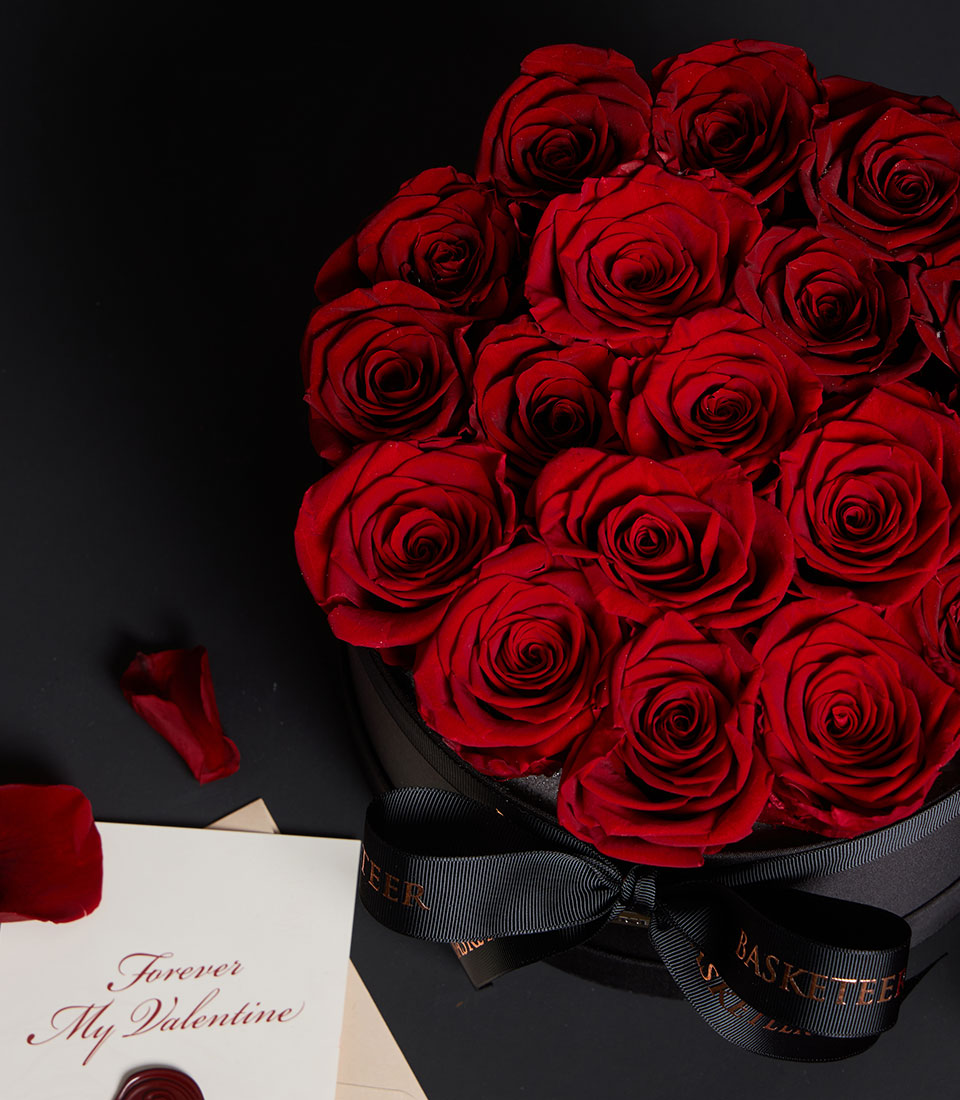Luxury red preserved roses in black round VIP gift box with gold ribbon bow, Valentine's Day gift