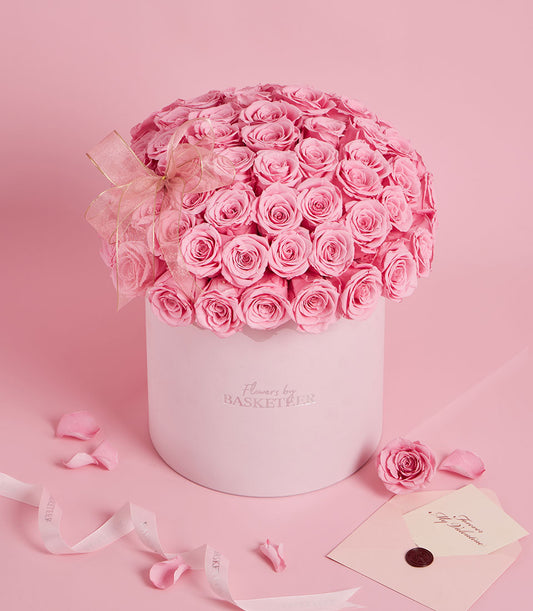 Flowers by Basketeer premium flowers Bangkok: Pink preserved roses in a grand round box, tied with delicate ribbon. Elegant rose bouquet Thailand delivery.