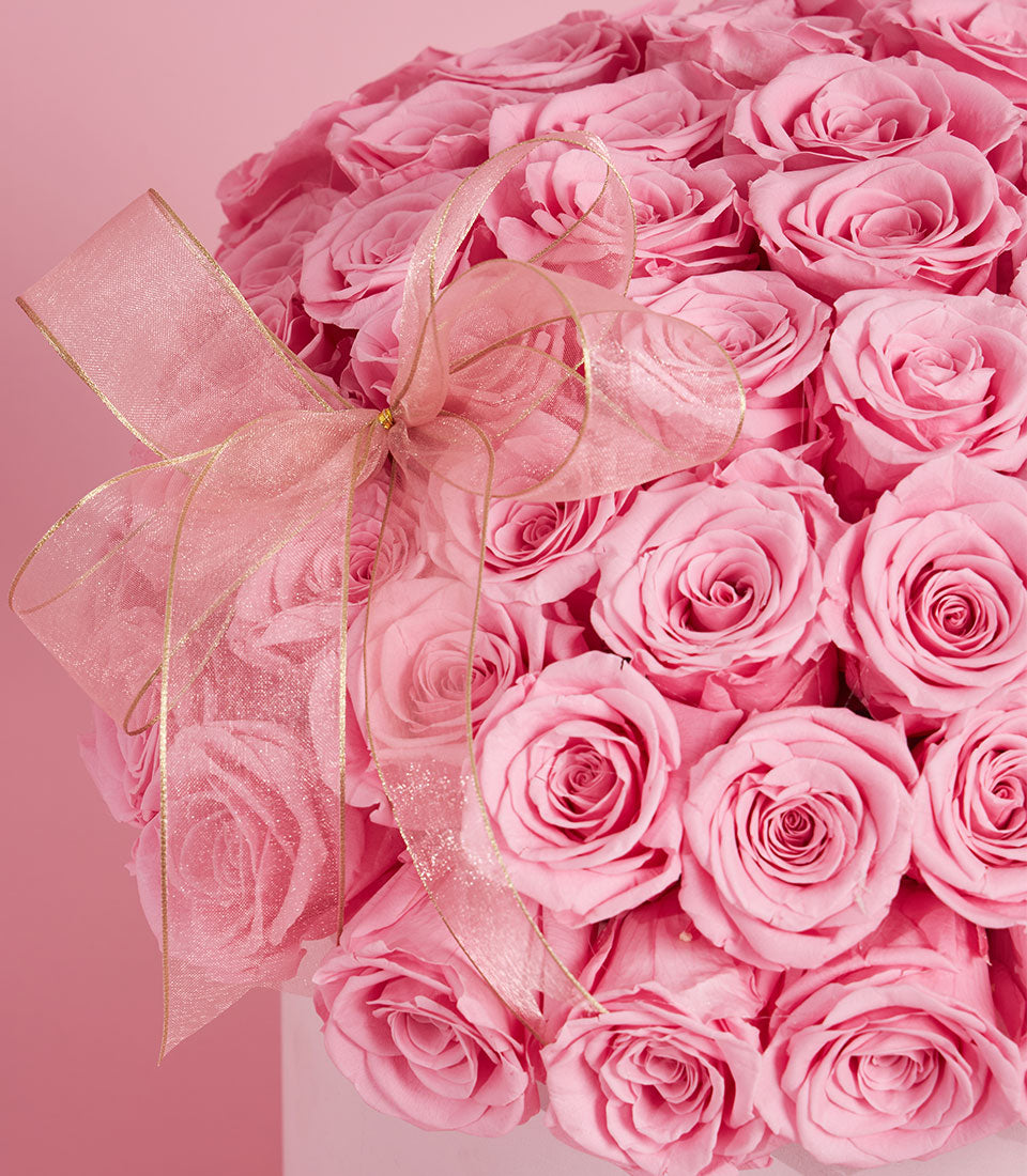 Lush pink rose arrangement in a grand round box from Flowers by Basketeer. The premium flower delivery Bangkok includes a delicate sheer ribbon.