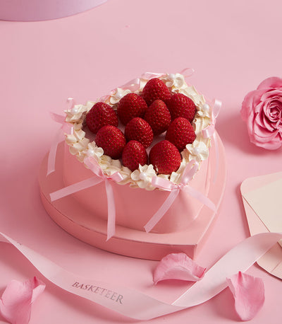 Charlotte Bakery heart-shaped custom cake: fresh strawberries nestled in whipped cream, delicate pink ribbon, for birthday cake delivery Bangkok.