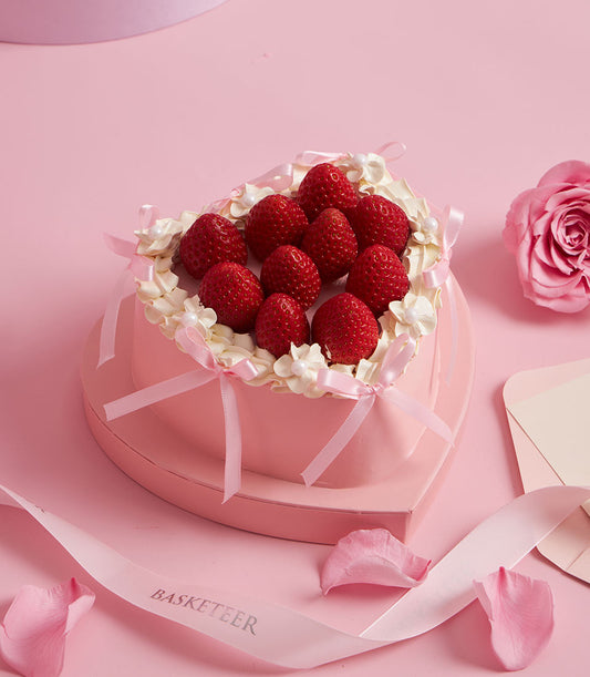 Charlotte Bakery heart-shaped custom cake: fresh strawberries nestled in whipped cream, delicate pink ribbon, for birthday cake delivery Bangkok.