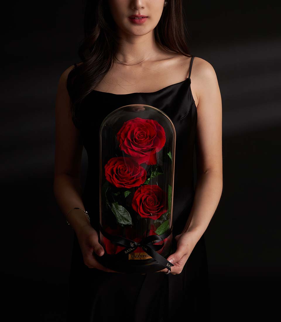 Flowers by Basketeer presents a preserved red rose arrangement in a glass dome, a premium Valentine gift for flower delivery in Bangkok. Luxurious, same-day delivery available.